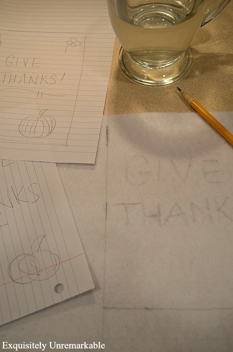 Give Thanks Embroidery Design on paper in pencil with a cup of hot water