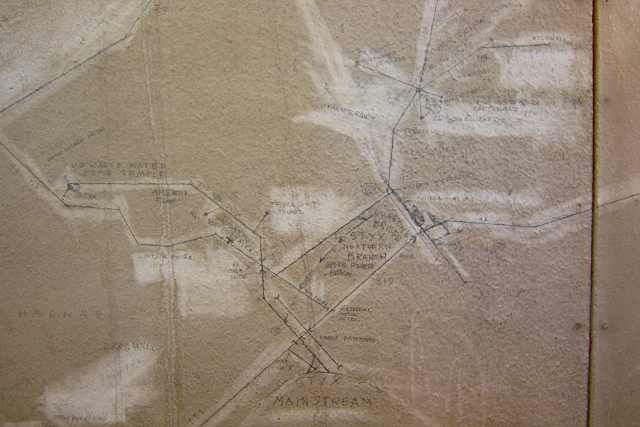 a drawing of a map on a worn wall, with names like Styx River written on the map that depicts a sewer system in central Helsinki. a drawing of a map on a worn wall, with names like Styx River written on the map that depicts a sewer system in central Helsinki.