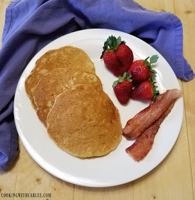 Pancakes loaded with the good stuff, whole grains, banana, yogurt and no added sugar! They are soft and flavorful and ready to be your breakfast! breakfast plate with banana pancakes, bacon and berries