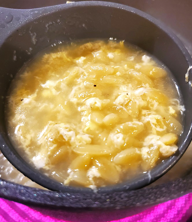 this is a pot full of egg drop soup with pastina in it called orzo