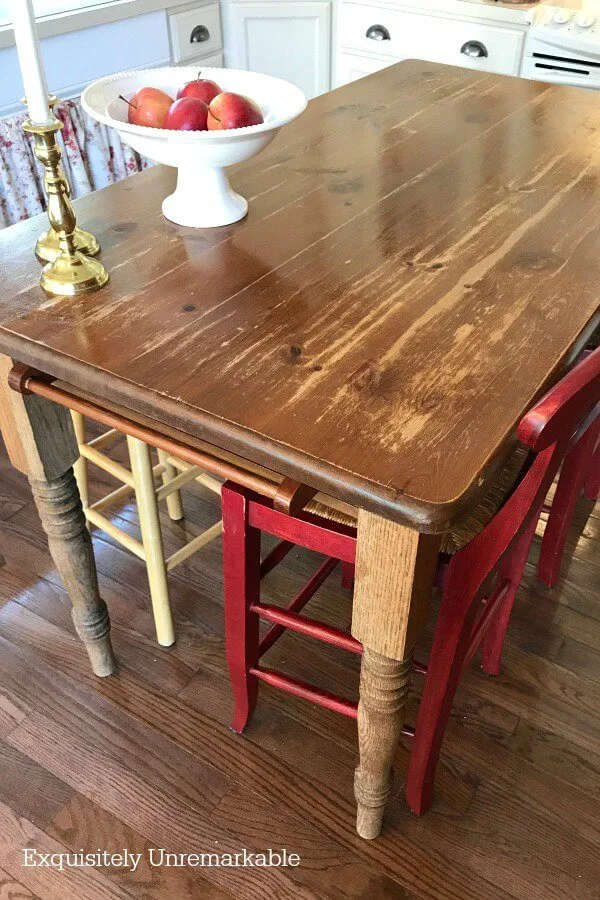 Wooden table with damage and wear spots in the kitchen