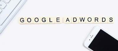 Lettered tiles spelling out adwords with a cell phone in the corner.