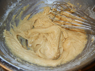 dough for cookies in a metal bowl with a metal whisk 