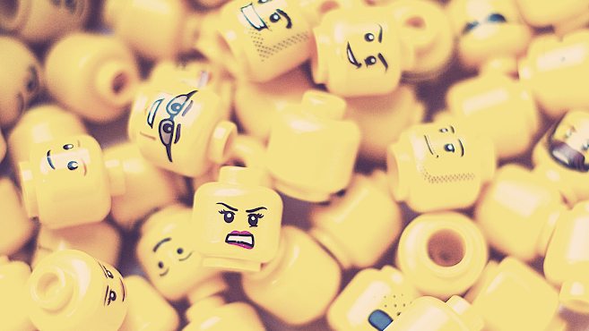 Yellow lego faces depicting a range of feelings - happy, sad, determined, mad, curious, angry