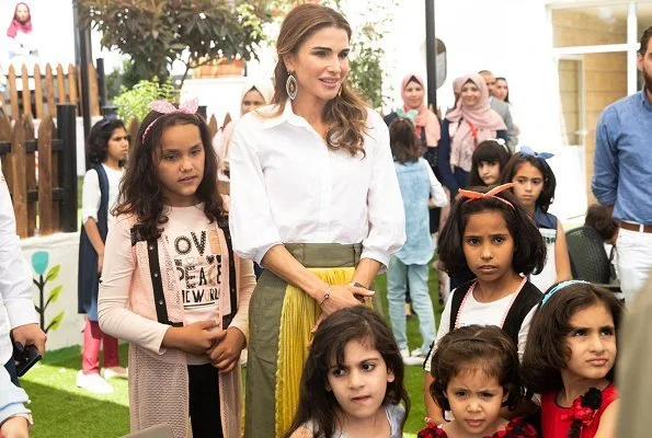 Queen Rania wore Sacai pleated midi skirt, Maison Makarem balloon shirt, Dior pumps and she carried Marni Trunk shoulder bag