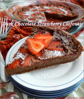 Dark Chocolate Strawberry Clafoutis is a beautiful light summer dessert. Whisk up the batter, top with fruit and bake. Serve warm, dusted with powdered sugar. | Recipe developed by www.BakingInATornado.com | #recipe #chocolate #dessert