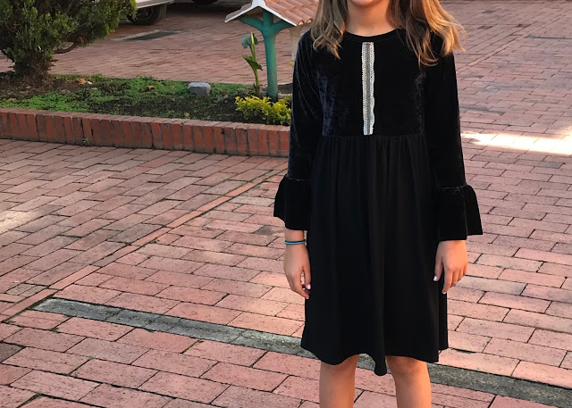 Girls' DIY black velvet bell sleeve dress from a free pattern.