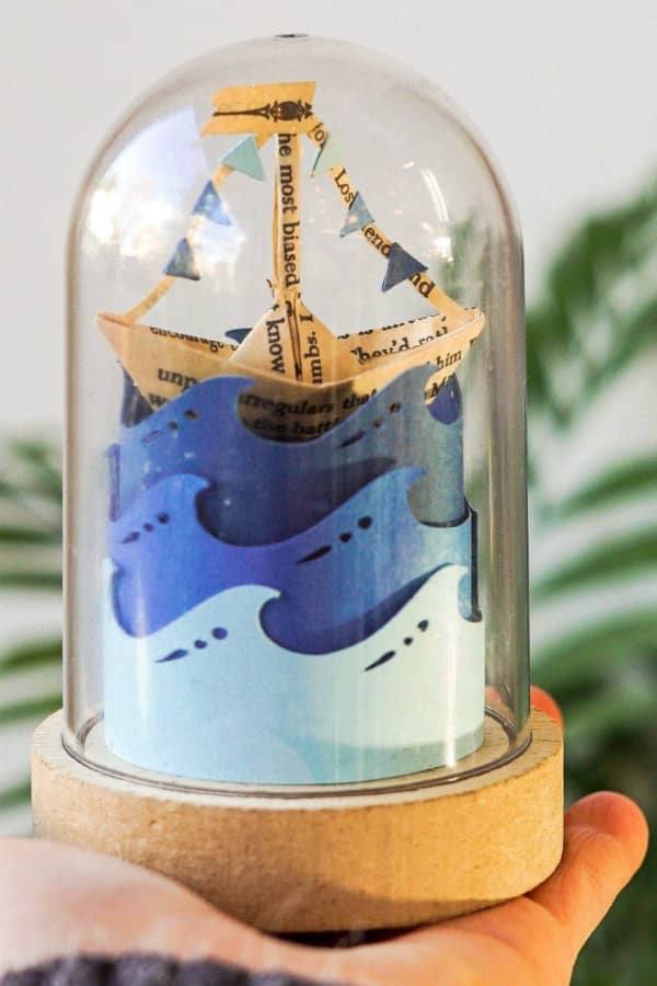 paper craft ship scene in glass dome