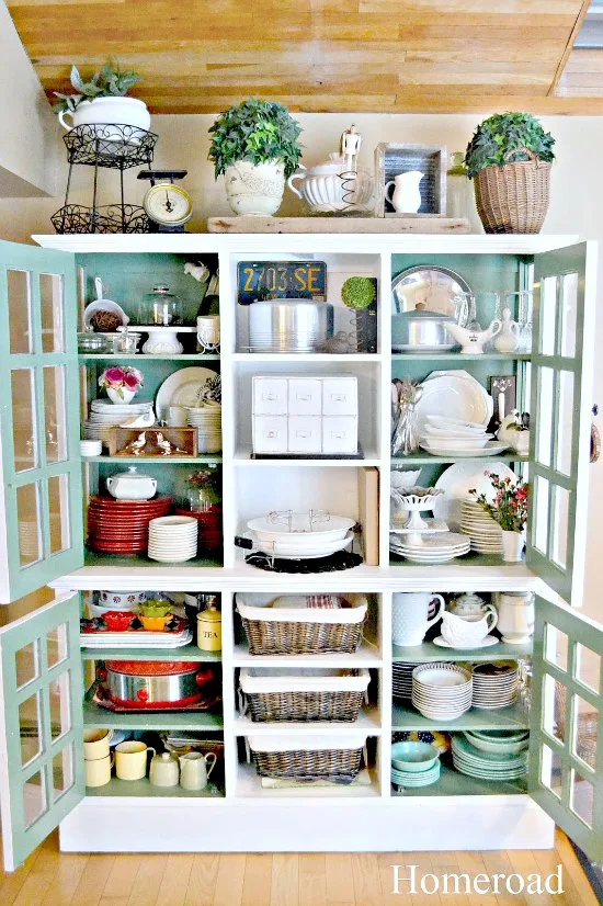 Large hutch with the doors open and packed with dishes