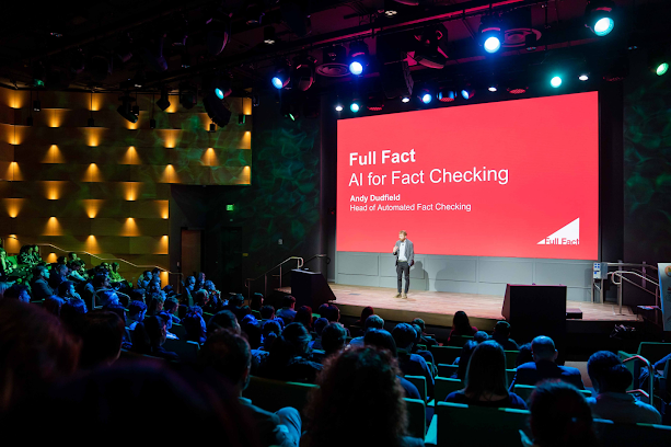 This is a photo of a conference hall during the talk by Andy Dudfield, Head of Automated Fact checking