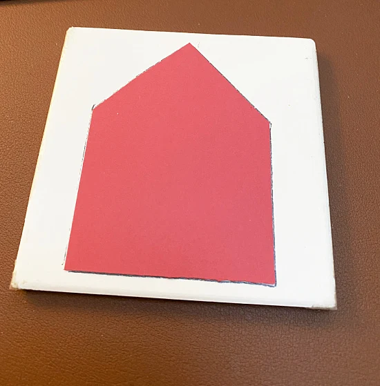 red card stock house shape traced on to tile