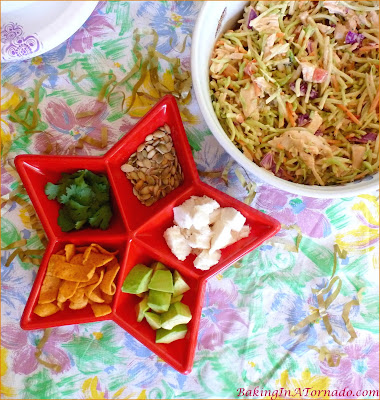 Spicy Broccoli Slaw and Chicken Salad, for lunch or for dinner on a hot summer night. Mix just a few ingredients together, refrigerate, let everyone choose their favorite toppings when you're ready to serve. | Recipe developed by www.BakingInATornado.com | #recipe #salad #chicken