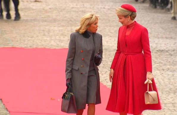 Queen Mathilde wearing a Christian Dior couture coat dress. Brigitte Macron wore Ralph Louren coat, dress and pumps