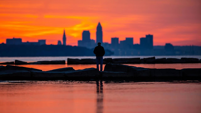 Silhouette image of man alone at sunset of the city Silhouette image of man alone at sunset of the city