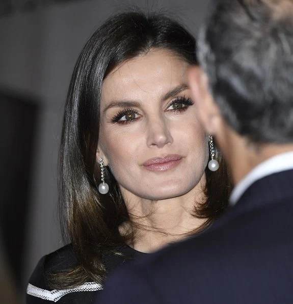 Queen Letizia wore a new flare striped cocktail dress by Carolina Herrera