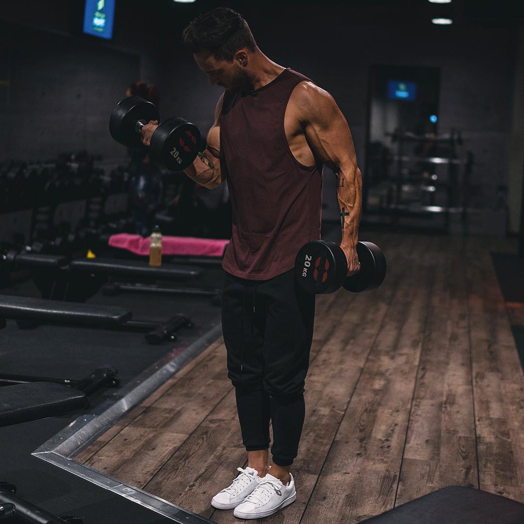 handsome-man-gym-working-out-veiny-arms-slim-hipster-lifting-weights