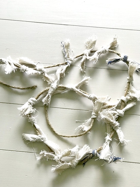 white fabric scraps tied on rope first