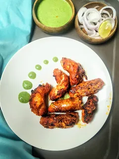 Chicken Rozali kebab in a serving plate with green chutney