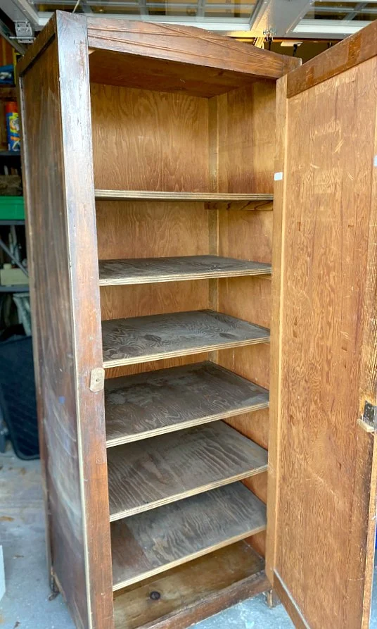 Large unfinished cupboard with open door