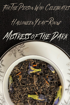 a cup full of tea leaves with text reading "for the person who celebrates halloween year-round: mistress of the dark"