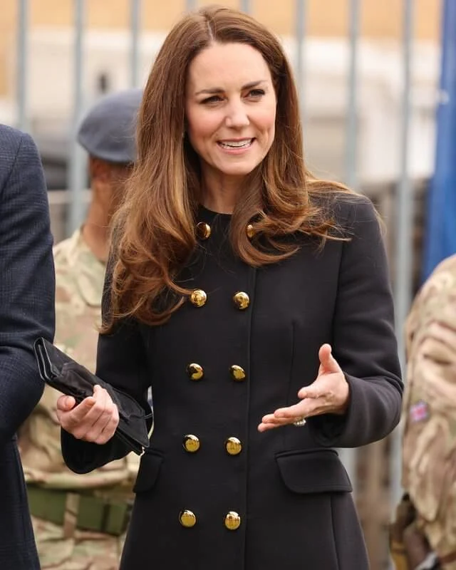 Kate Middleton wore a collarless long coat from Dolce & Gabbana, and suede pumps from Tod's. She carried Mulberry Bayswater clutch