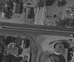 A close-up of the rural aerial photograph showing a round building.