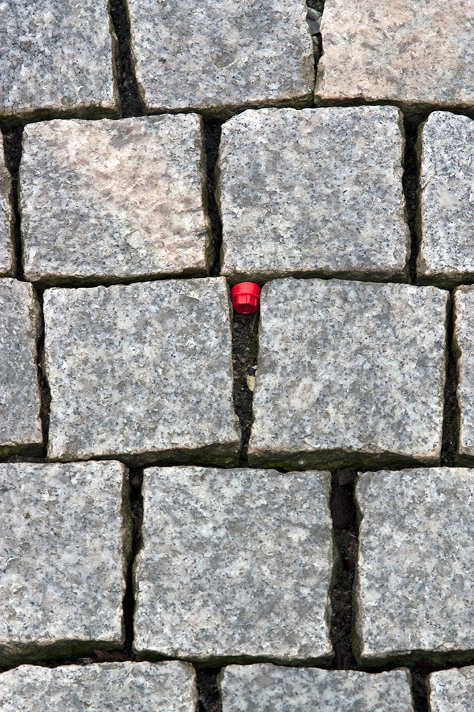 red cap in sidewalk