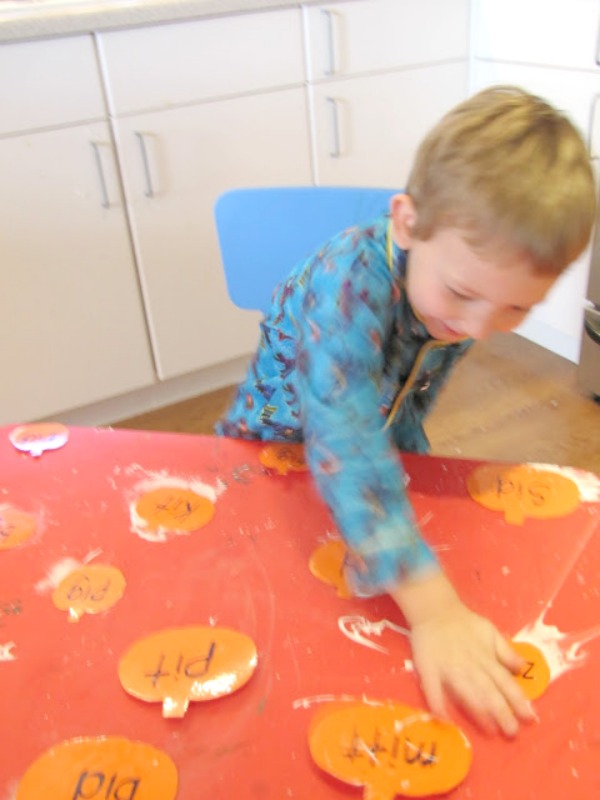 Sight word smash game that is a messy way to learn sight words by smashing paper pumpkins with shaving cream underneath.