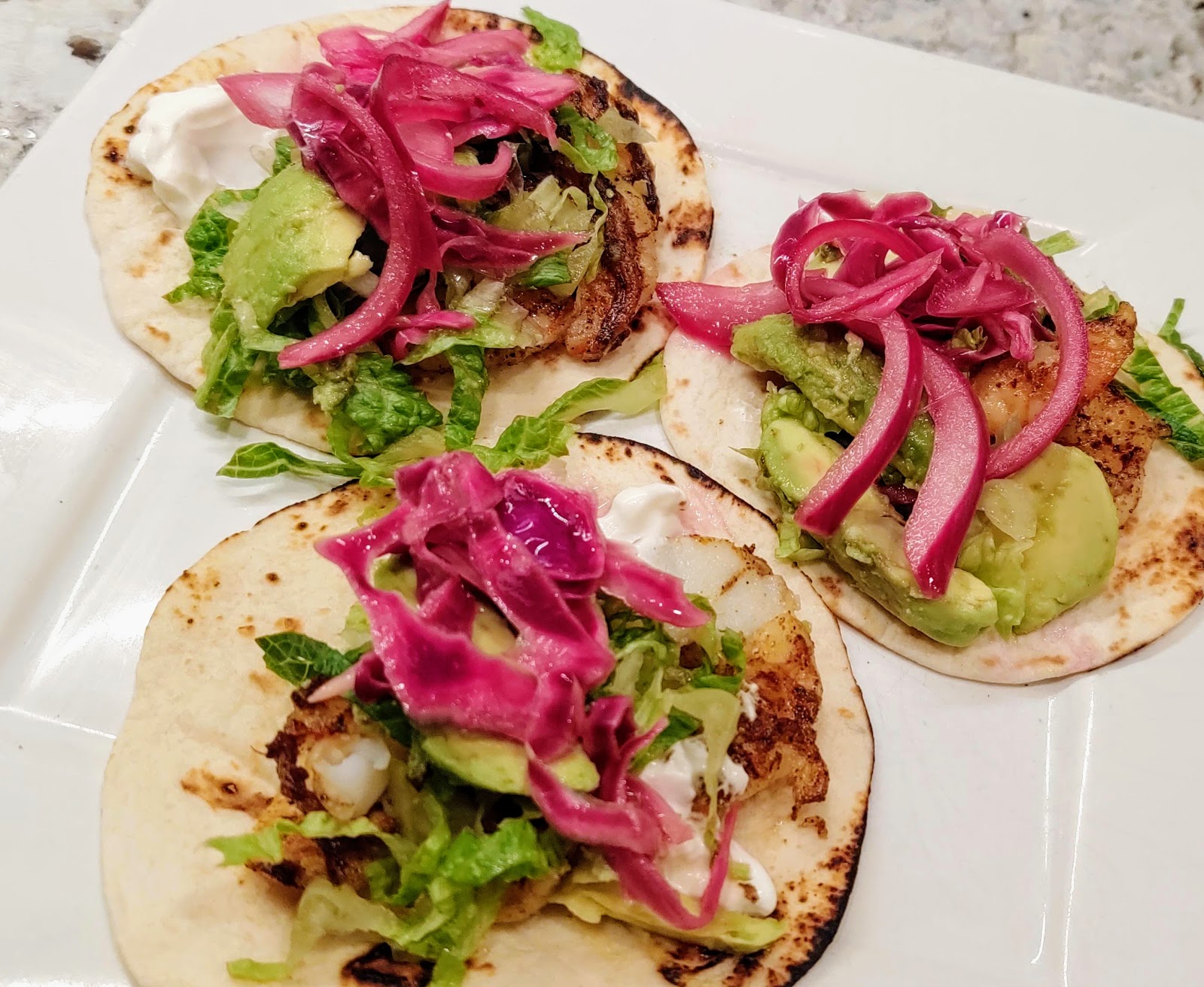 Shrimp Street Tacos with Avocado and Pickled Onion and cabbage