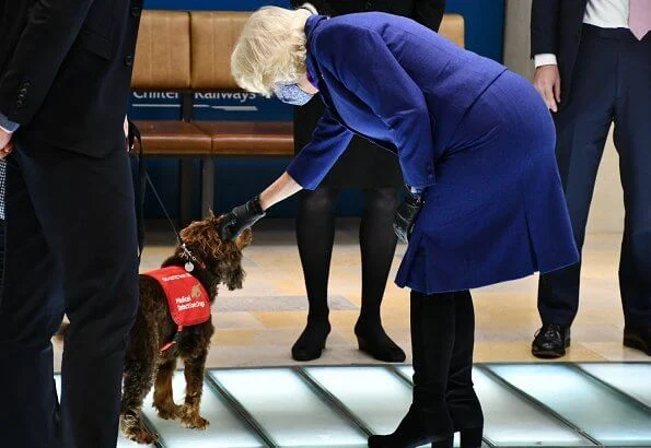 Duchess of Cornwall visited Paddington Station to watch a demonstration by the charity Medical Detection Dogs. blue navy blazer