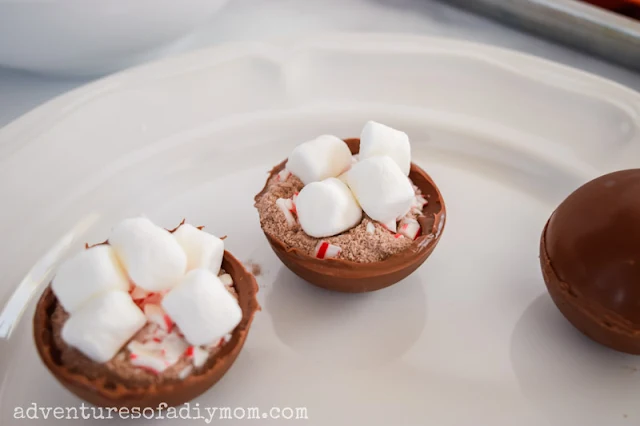 hot chocolate bomb shells filled with cocoa mix, crushed candy canes and small marshmallows