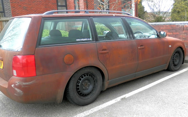 Car painted to look as though it is rusty