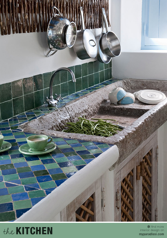 An ethnic kitchen with stone sink and colored tiles by Vera Iachia.