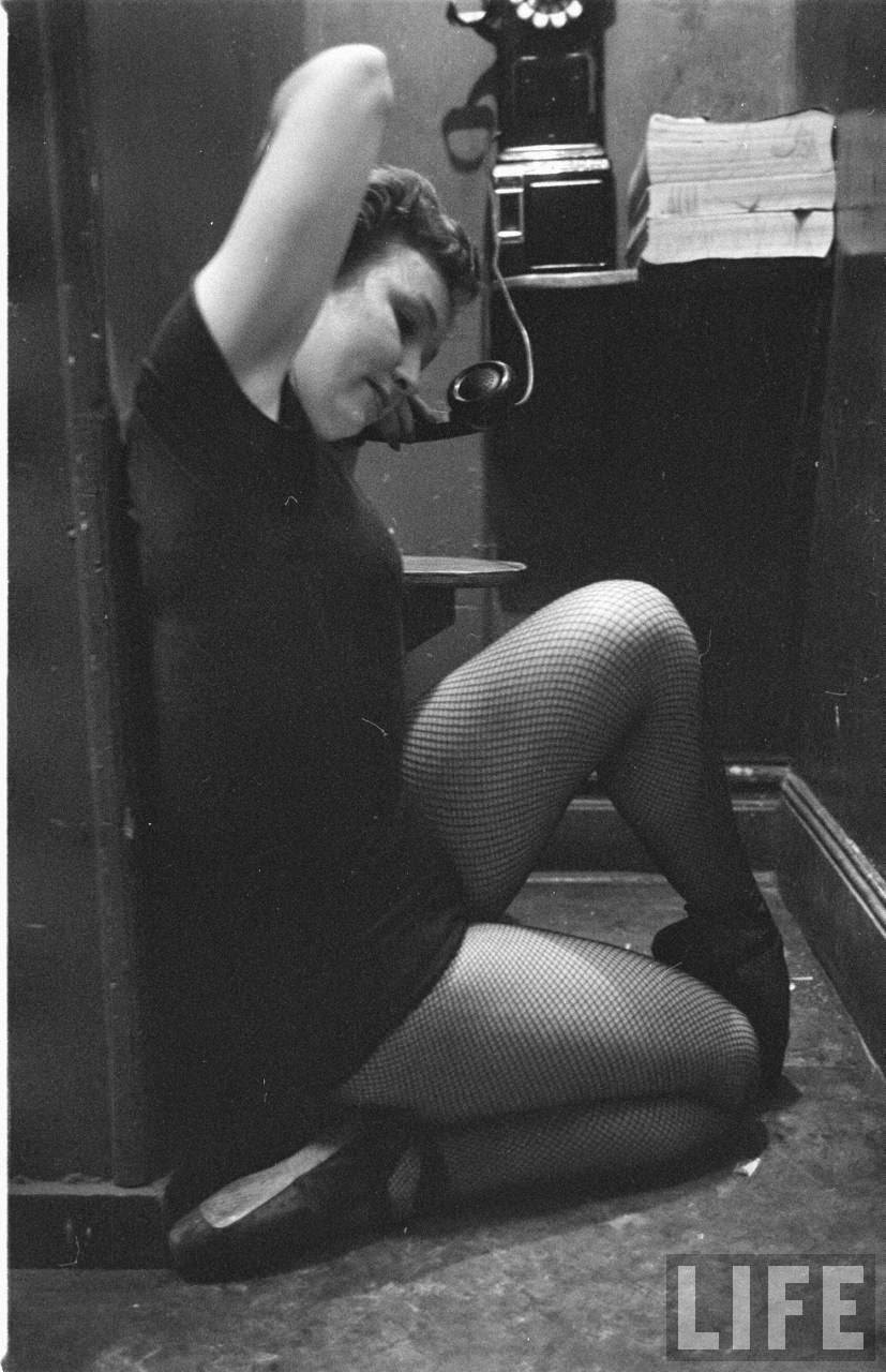 Mary Ellen Terry Talking With Her Legs Up in a Telephone Booth in 1952.