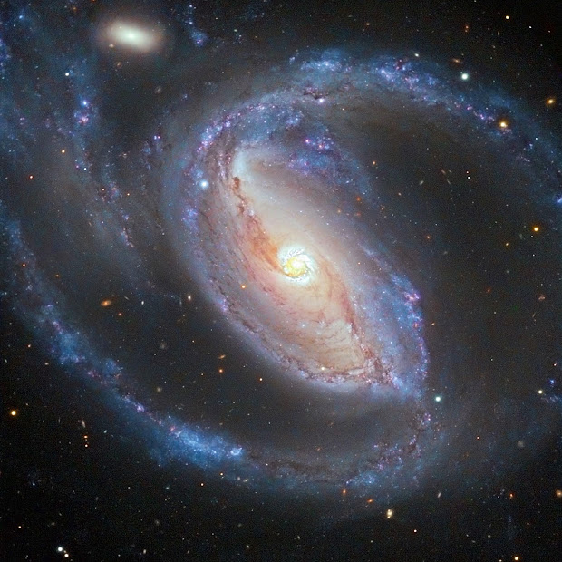 NGC 1097 and NGC 1097A spied in a galactic embrace!