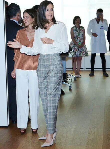 Hugo Boss prince of wales checked trousers, and Boss white silk blouse, and Magrit pumps, diamon earrings