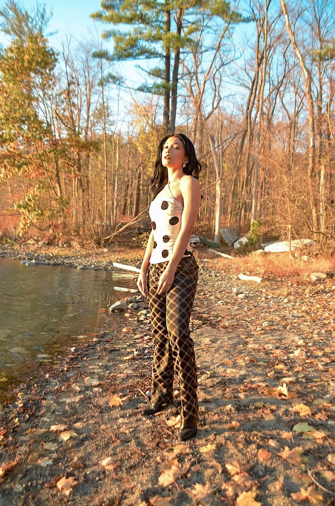 Versace logo pants, brown beige medusa logo, Jacquemus polka dot top strapple top, beige top with black dots, trees and leaves and a lake in the background, fall mood, North Salem, NY 2020