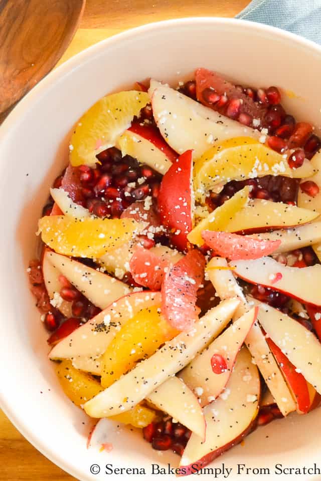Winter Fruit Salad is filled with Oranger, Grapefruit, Pears, and Pomegranate Seeds with an easy Feta Poppy Seed Dressing. A favorite for Thanksgiving and Christmas from Serena Bakes Simply From Scratch.