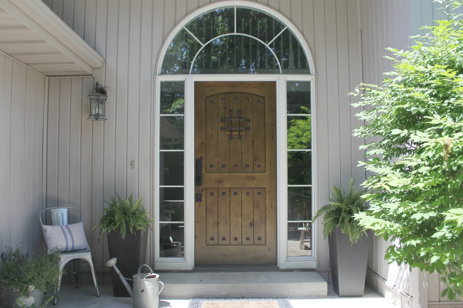 Knotty alder front door (Pacific Entries) and country courtyard by Hello Lovely Studio