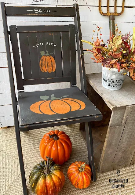Photo of a wooden folding chair painted and stenciled as fall decor