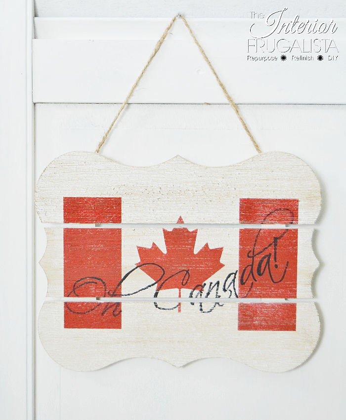 Sign for Canada Day, an easy patriotic craft idea using an upcycled dollar store wood plank and Canadian flag stencil.