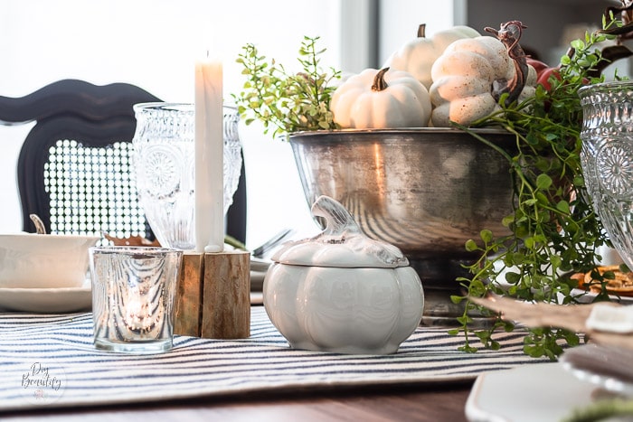 table set with pumpkins, mixed metals and natural elements