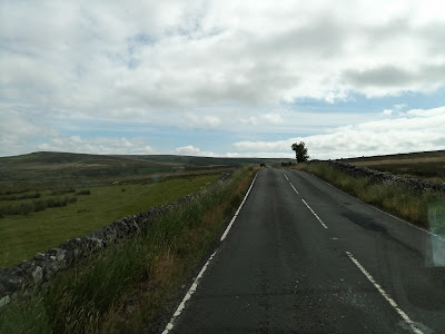Photo of the road ahead - empty and climbing higher into the open countryside.