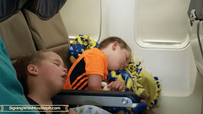 Exhausted boys sleeping on a plane