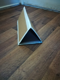 a completed triangular receptacle with tape on all connected sides
