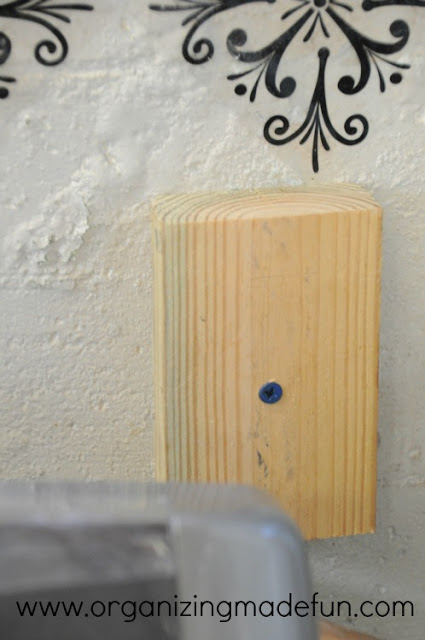 Cement screws in wood blocks in the wall | OrganizingMadeFun.com