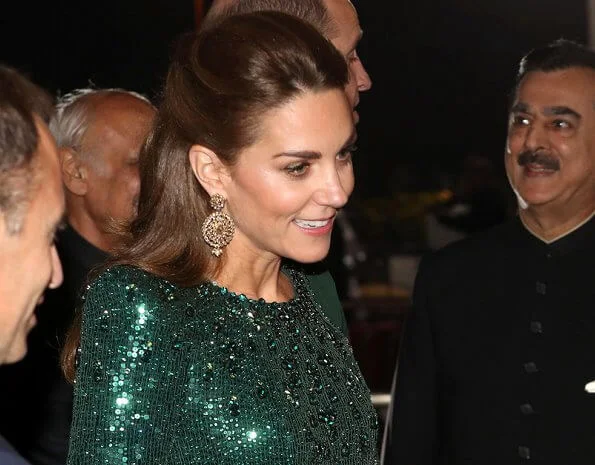 Kate Middleton wore a sparkling emerald green gown by Jenny Packham, and earrings by O'nita. Prince William wore a traditional Sherwani by Naushemian