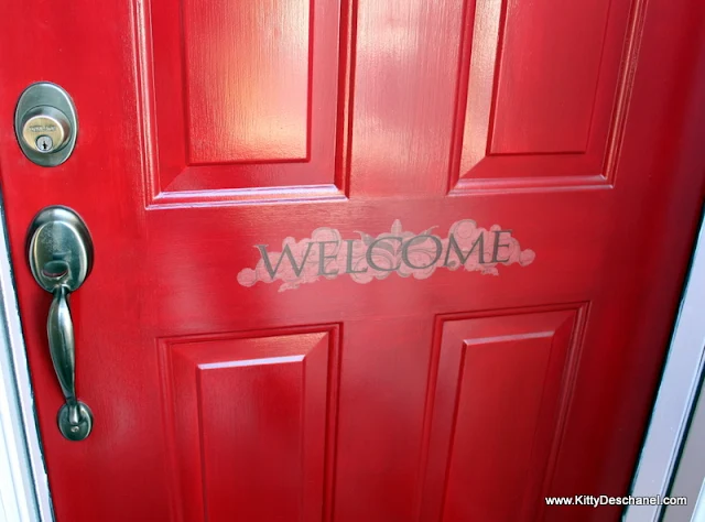 welcome decal on a red front door