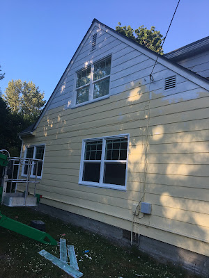 exterior of house painted on second floor with primer