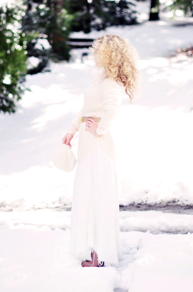 big blonde afro curls, light neutrals in the snow, winter style